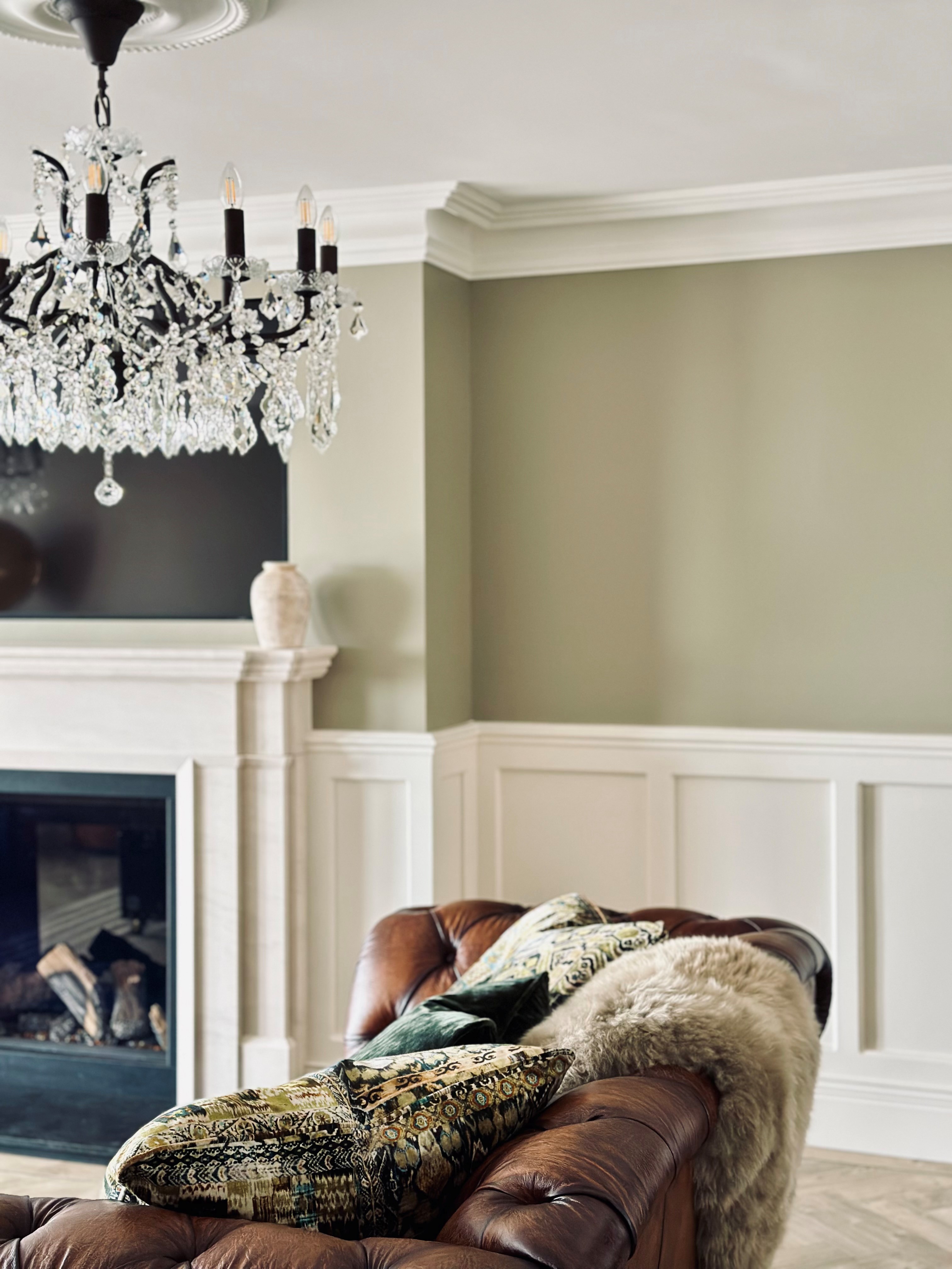 wooden circular table with geometric wallpaper