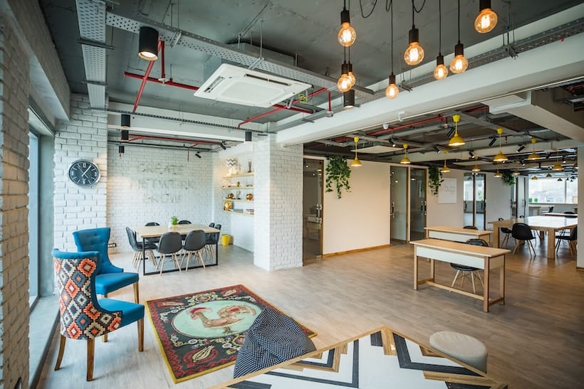 A modern office with a large table and chairs.